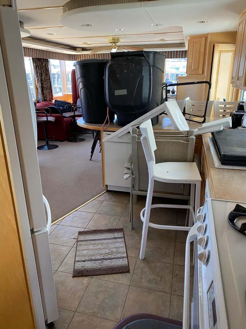 Slide: The Image of Interior of 2003 Stardust Cruisers Red Rock Retreat Week 26 houseboat with disorganized furniture. - 17