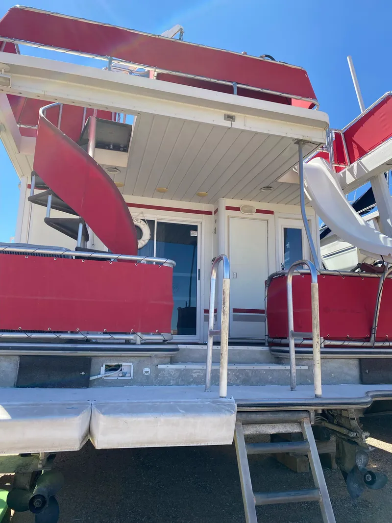 Slide: The Image of 2003 Stardust Cruisers Red Rock Retreat Week 26 houseboat with red accents and spiral staircase. - 3