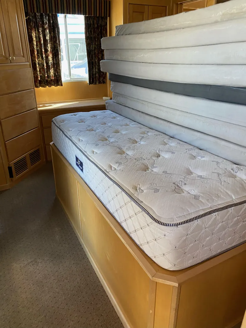 Slide: The Image of 2003 Stardust Cruisers Red Rock Retreat Week 26 interior with stacked mattresses. - 7