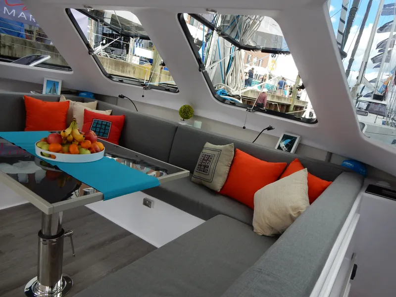 Slide: The Image of Luxurious interior of 2025 Seawind 1190 Sport catamaran with modern seating and vibrant cushions. - 11