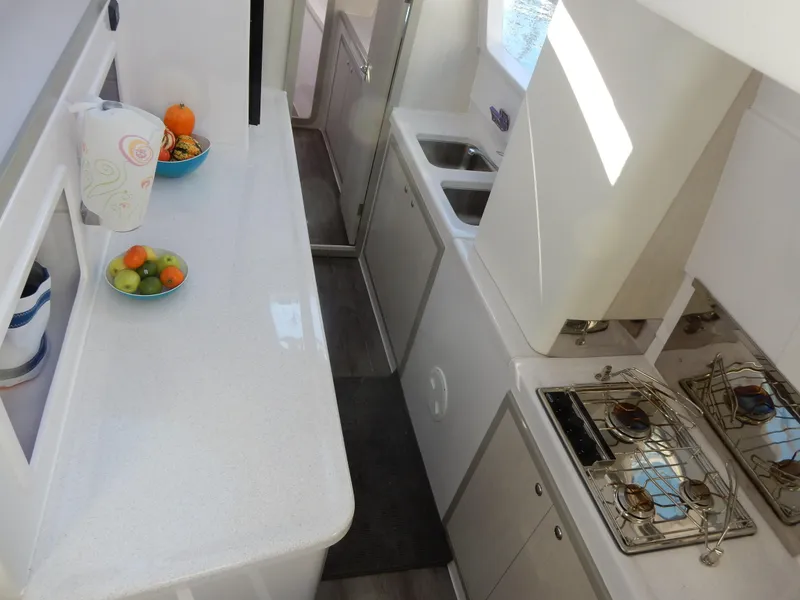 Slide: The Image of 2025 Seawind 1190 Sport yacht kitchen with modern appliances and sleek countertops. - 13