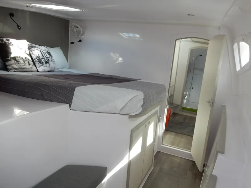 Slide: The Image of 2025 Seawind 1190 Sport interior cabin with bed, modern design, and natural lighting. - 7