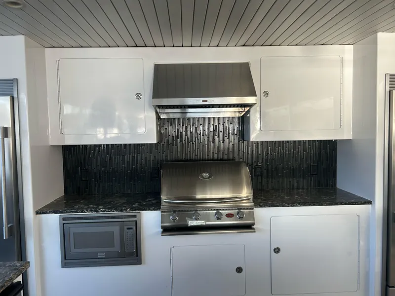 Slide: The Image of Modern kitchen with stainless steel appliances, black tile backsplash, and white cabinetry in 2016 Adonia Aquarius. - 15