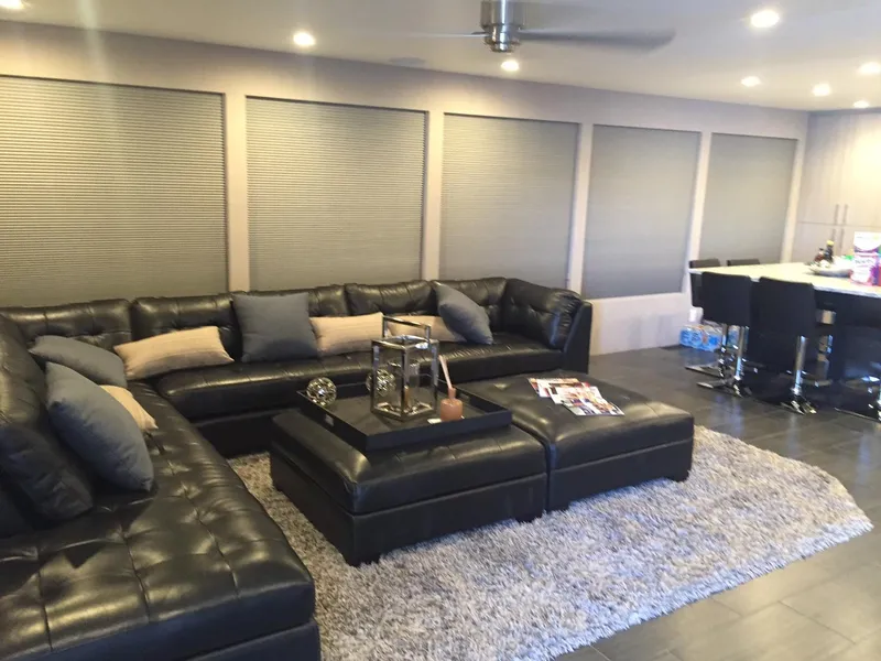 Slide: The Image of Luxurious living area in 2016 Adonia Aquarius, featuring black leather sectional and modern decor. - 2