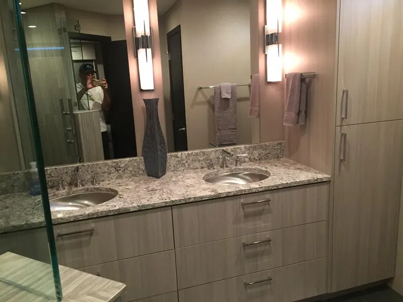 Slide: The Image of Modern bathroom with double sinks, granite countertop, and sleek cabinetry in Adonia Aquarius, 2016 model. - 5