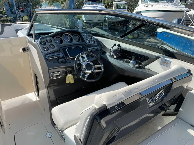 Slide: The Image of 2012 Monterey 328 Super Sport boat cockpit with steering wheel and control panel. - 12
