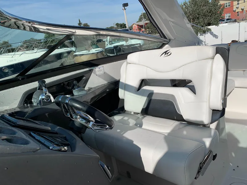 Slide: The Image of 2012 Monterey 328 Super Sport boat cockpit with white leather captain's seat. - 15