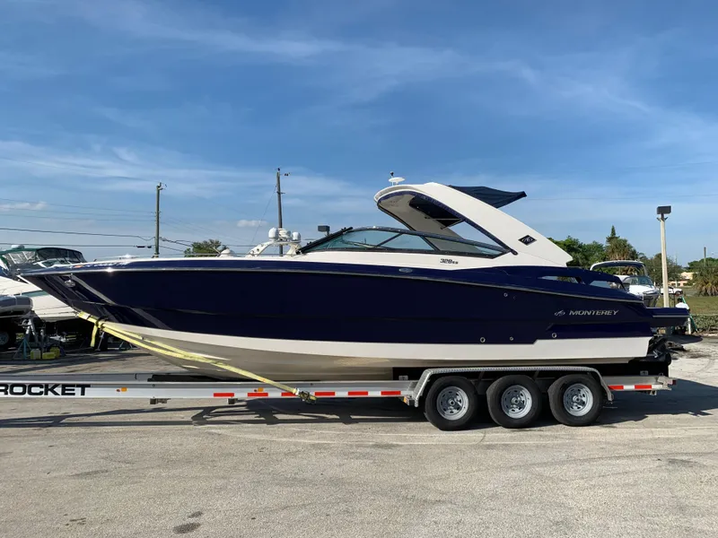 Slide: The Image of 2012 Monterey 328 Super Sport boat on a trailer, side view. - 2
