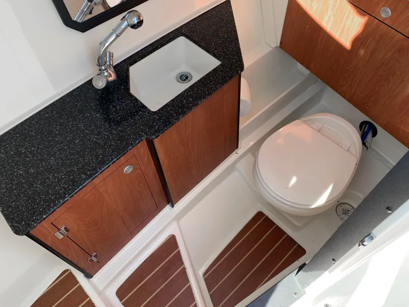 Slide: The Image of 2012 Monterey 328 Super Sport boat bathroom with sink, toilet, and wooden cabinets. - 20
