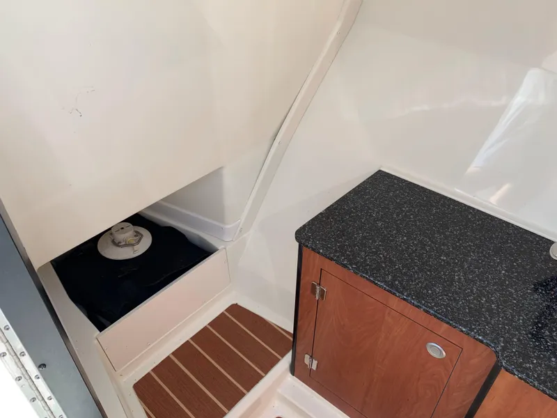 Slide: The Image of Interior of 2012 Monterey 328 Super Sport boat with storage and countertop. - 21