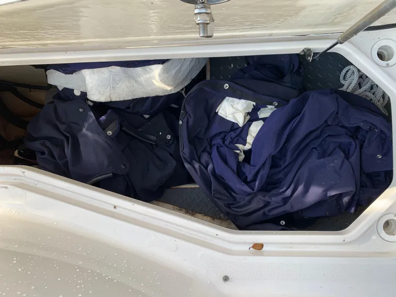 Slide: The Image of Storage compartment of a 2012 Monterey 328 Super Sport boat with blue covers. - 22