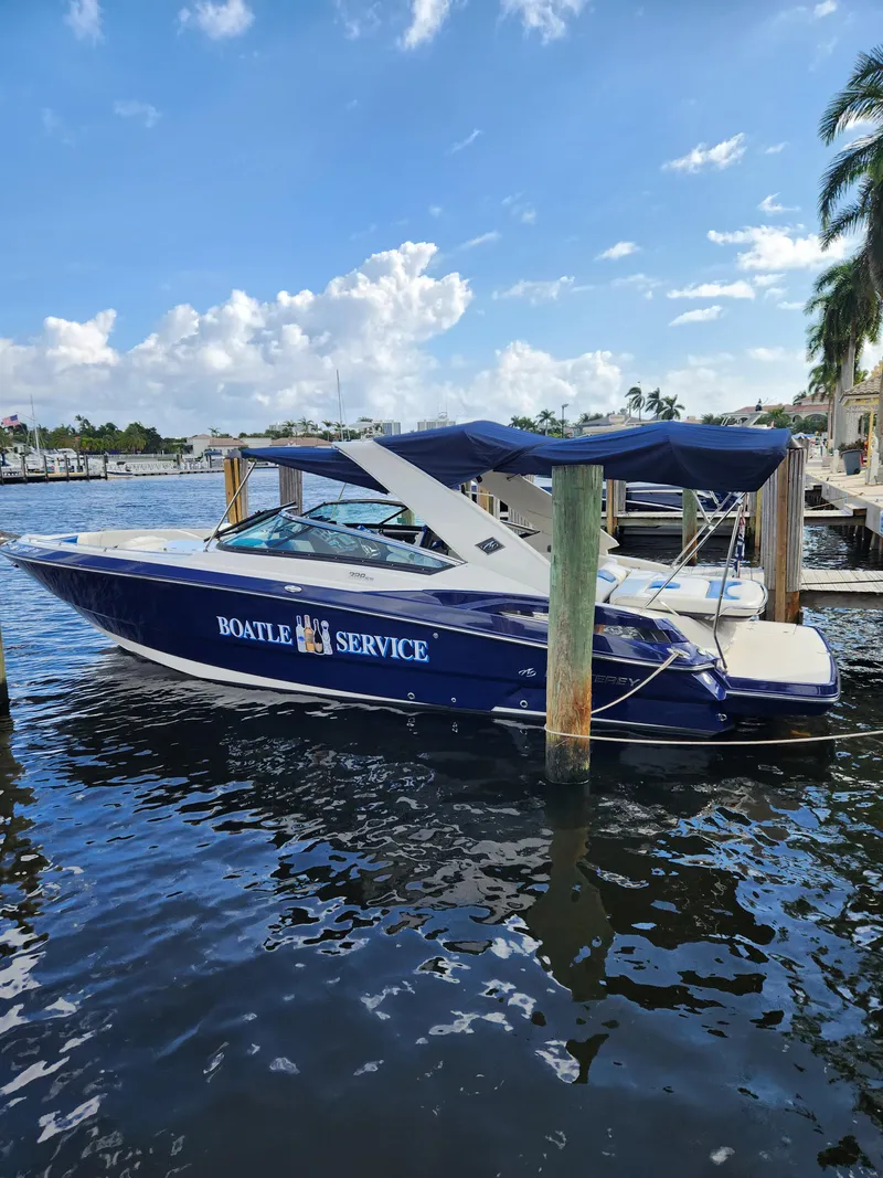Slide: The Image of 2012 Monterey 328 Super Sport boat docked with Boatel Service branding. - 27