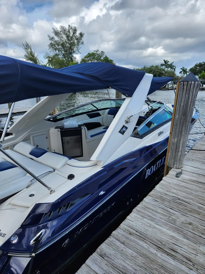 Slide: The Image of 2012 Monterey 328 Super Sport boat docked at a marina. - 29