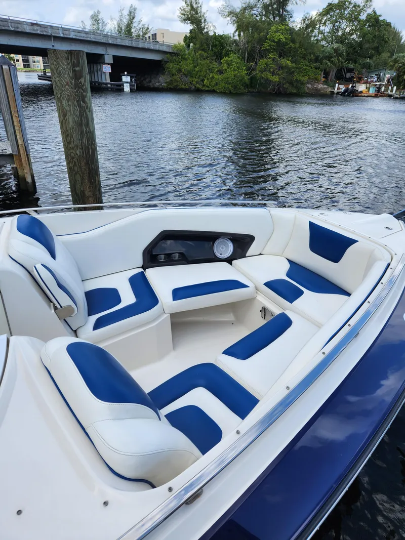 Slide: The Image of 2012 Monterey 328 Super Sport boat with blue and white seating on the water. - 30
