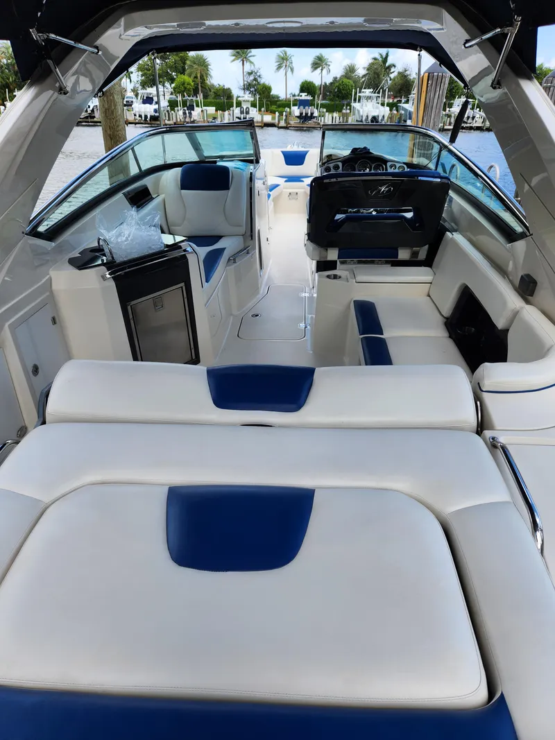 Slide: The Image of 2012 Monterey 328 Super Sport boat interior with white and blue seating. - 31