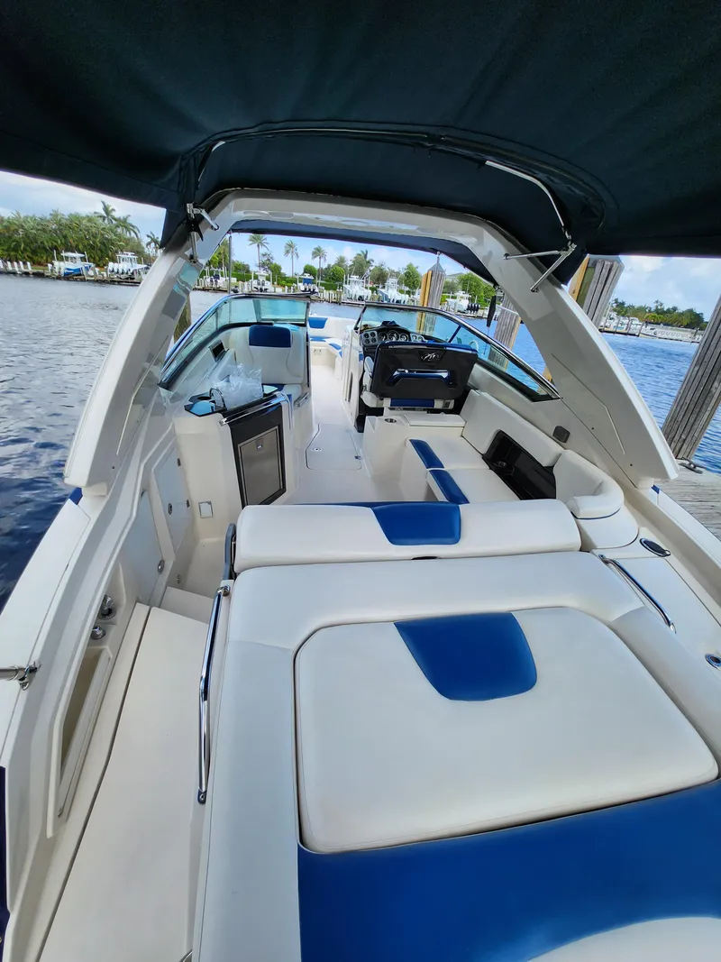 Slide: The Image of 2012 Monterey 328 Super Sport boat interior with blue and white seating. - 32