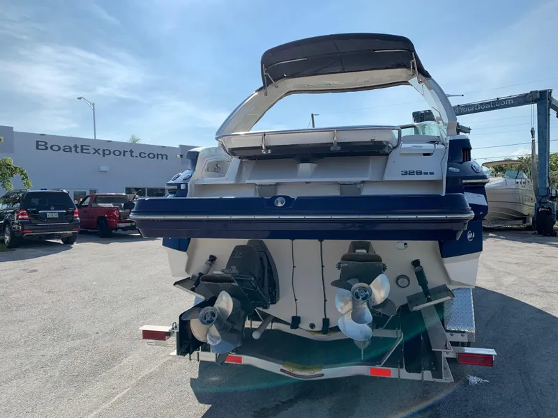 Slide: The Image of 2012 Monterey 328 Super Sport boat at a dealership, rear view with dual propellers. - 4