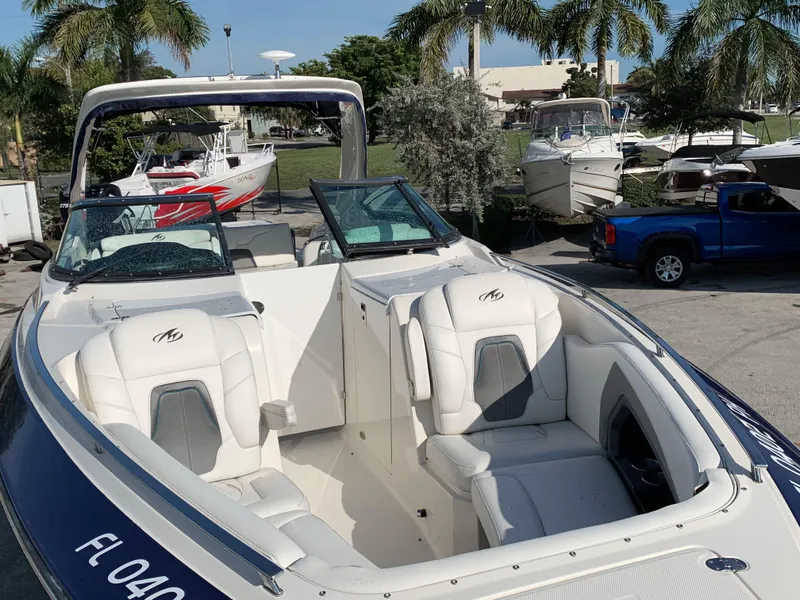 Slide: The Image of 2012 Monterey 328 Super Sport boat with white seating and blue exterior. - 7