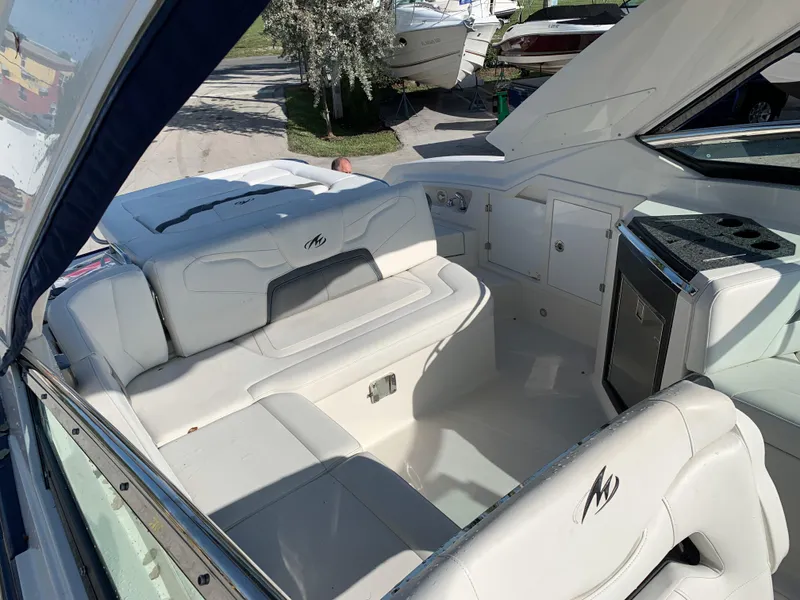 Slide: The Image of 2012 Monterey 328 Super Sport boat interior with white leather seating. - 8