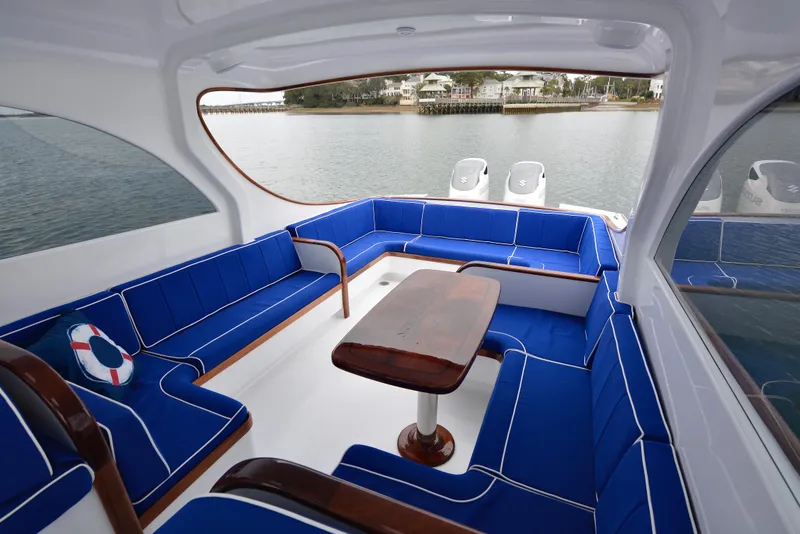 Slide: The Image of 2018 Maverick Yachts Costa Rica 32 Custom Carolina Picnic Boat with blue seating and wooden table. - 12