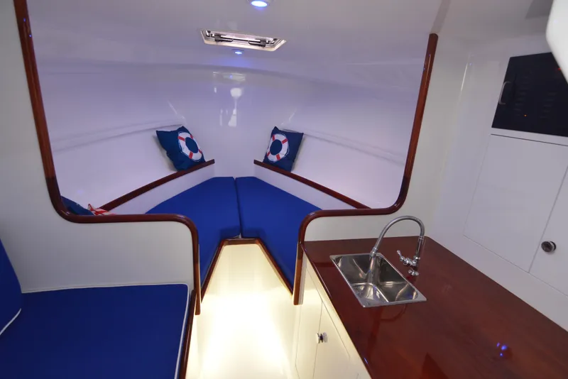 Slide: The Image of Interior of 2018 Maverick Yachts Costa Rica 32 Custom Carolina Picnic Boat with blue seating. - 3