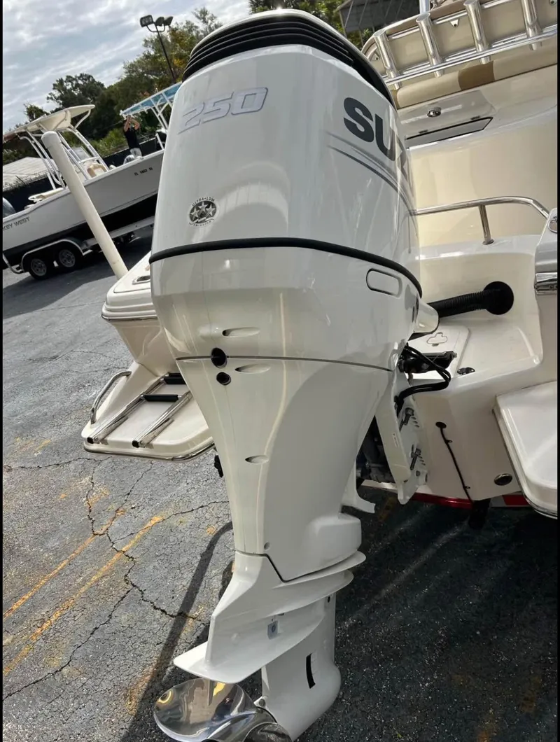 Slide: The Image of 2020 Pioneer 222 Sportfish with Suzuki outboard motor in a marina setting. - 7