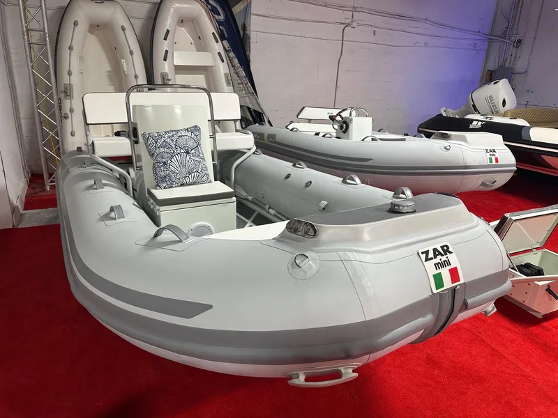 Slide: The Image of 2024 Zar Formenti ZAR Mini RIB 14 inflatable boat on display, red carpet background. - 4