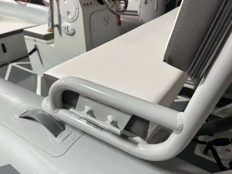 Slide: The Image of 2024 Zar Formenti ZAR Mini RIB 14 boat interior, featuring sleek seating and control panel. - 5