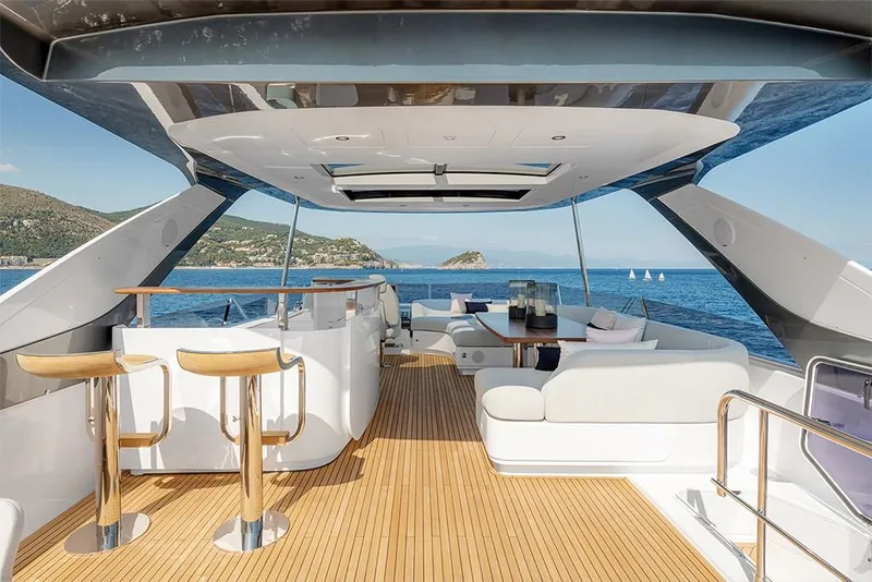 Slide: The Image of Luxurious 2023 Azimut 78 yacht interior with ocean view, featuring modern seating and bar stools. - 4