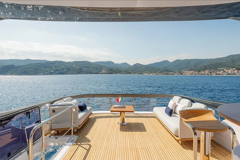 Slide: The Image of Luxury deck view on 2023 Azimut 78 yacht, overlooking serene blue waters and distant mountains. - 5