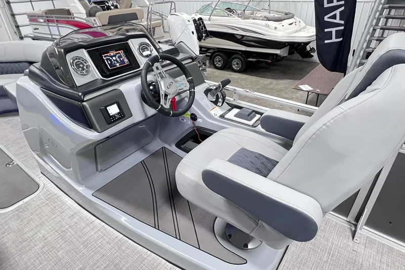 Slide: The Image of Interior view of 2022 Harris FloteBote SOLTHICE 250 boat cockpit with steering wheel and controls. - 10