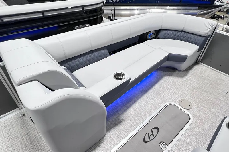Slide: The Image of 2022 Harris FloteBote SOLTHICE 250 pontoon boat interior with plush seating and ambient lighting. - 11