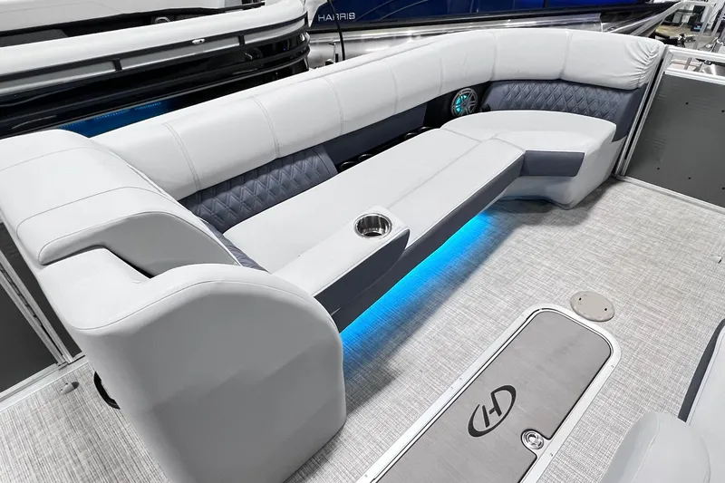 Slide: The Image of 2022 Harris FloteBote SOLTHICE 250 pontoon boat interior with plush seating and ambient lighting. - 13