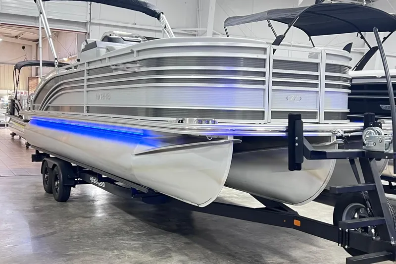 Slide: The Image of 2022 Harris FloteBote SOLTHICE 250 pontoon boat with blue LED lights on trailer. - 3