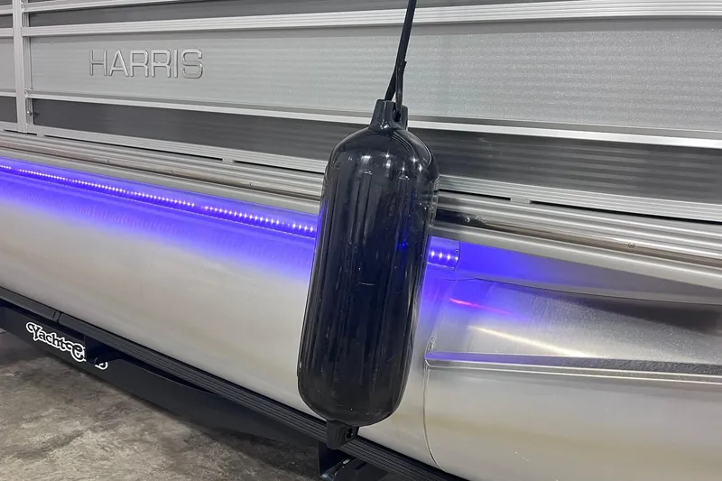 Slide: The Image of 2022 Harris FloteBote SOLTHICE 250 pontoon with blue LED lights and black fender. - 39