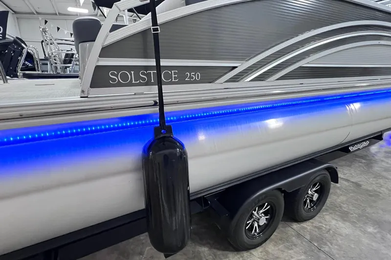 Slide: The Image of 2022 Harris FloteBote SOLTHICE 250 pontoon boat with blue LED lights on trailer. - 41