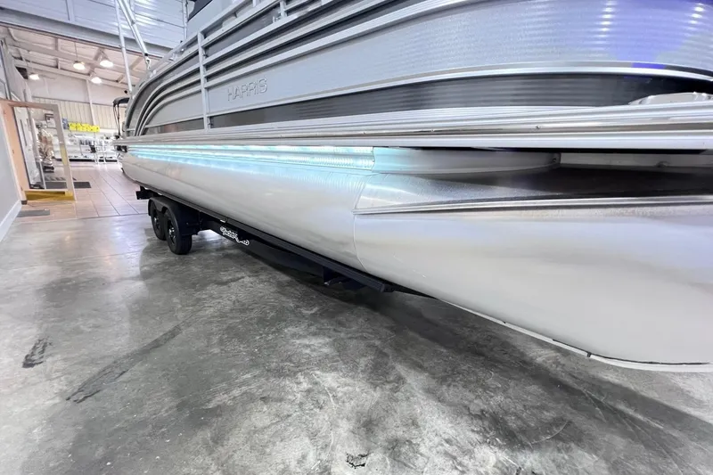 Slide: The Image of 2022 Harris FloteBote SOLTHICE 250 pontoon boat in showroom, side view with trailer. - 42