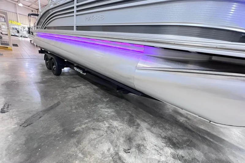 Slide: The Image of 2022 Harris FloteBote SOLTHICE 250 pontoon boat with purple LED lights on trailer. - 43