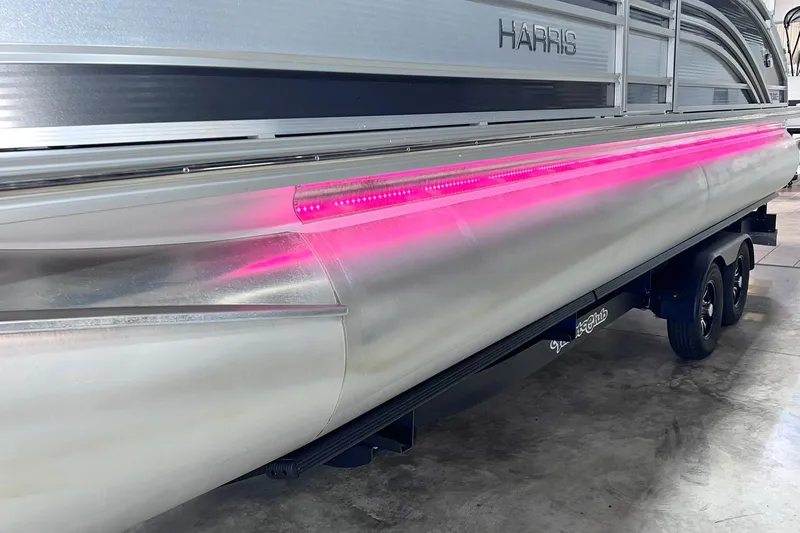 Slide: The Image of 2022 Harris FloteBote SOLTHICE 250 pontoon boat with pink LED lighting on trailer. - 45