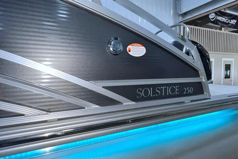 Slide: The Image of 2022 Harris FloteBote SOLSTICE 250 pontoon boat with sleek design and illuminated accents. - 48