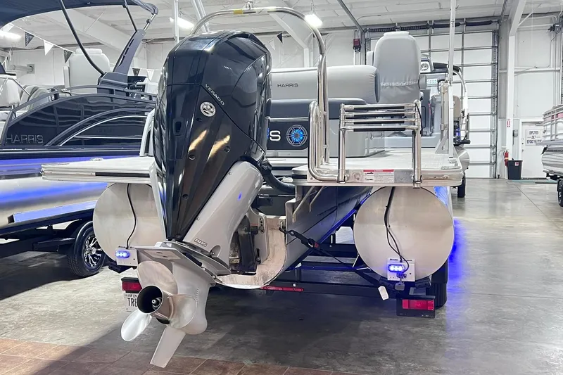Slide: The Image of 2022 Harris FloteBote SOLTHICE 250 pontoon boat with powerful outboard motor in showroom. - 5