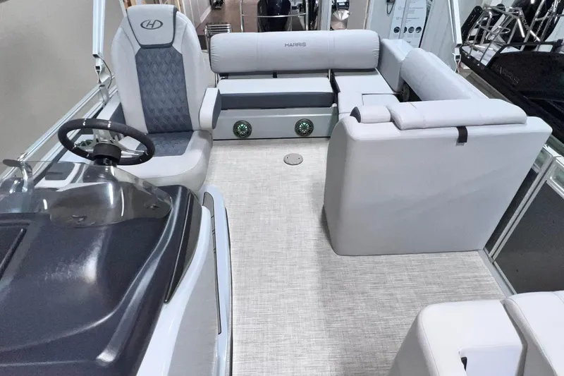 Slide: The Image of 2022 Harris FloteBote SOLTHICE 250 pontoon boat interior with plush seating and steering console. - 9