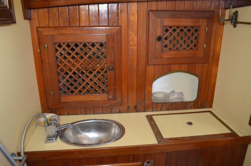 Slide: The Image of 1982 Young Sun Cutter interior with wooden cabinets and stainless steel sink. - 10