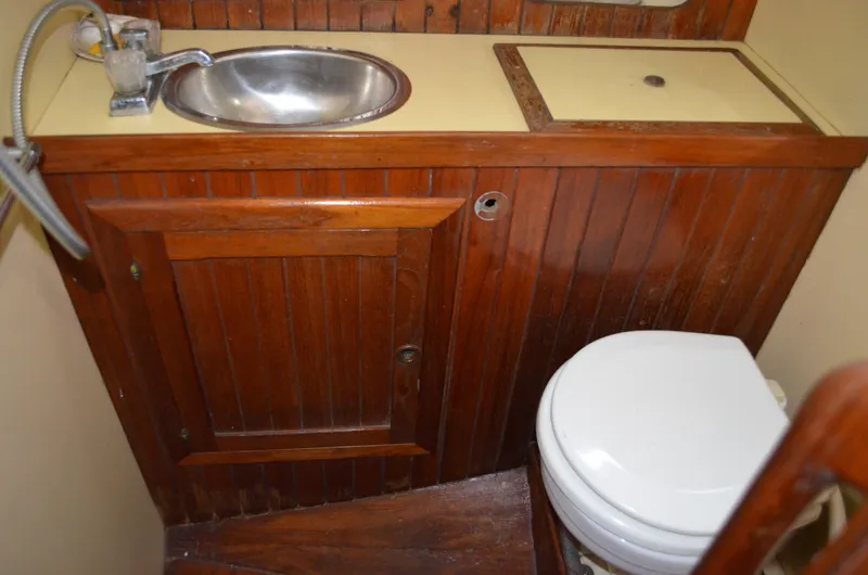 Slide: The Image of 1982 Young Sun Cutter bathroom with wooden cabinetry, sink, and toilet. - 11