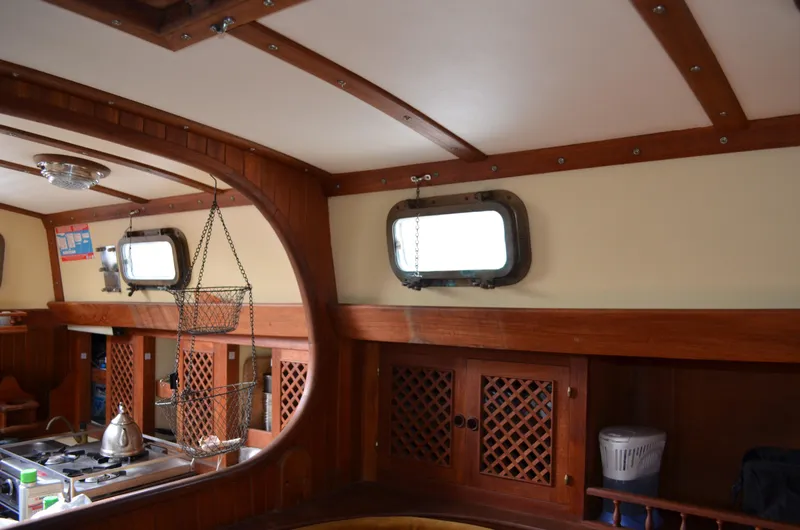 Slide: The Image of Interior of 1982 Young Sun Cutter sailboat with wooden cabinetry and portholes. - 13