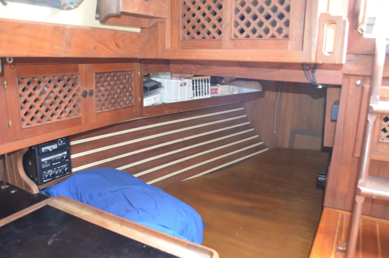 Slide: The Image of 1982 Young Sun Cutter interior with wooden cabinetry and blue bedding. - 15