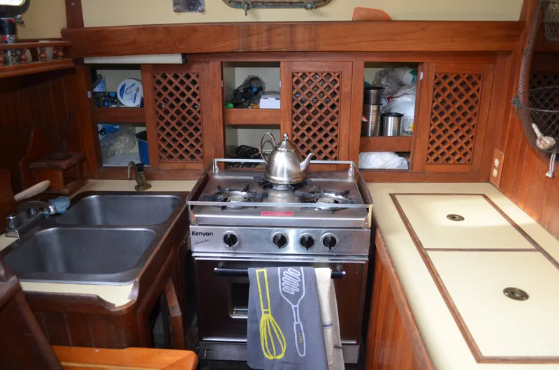 Slide: The Image of 1982 Young Sun Cutter kitchen with stove, sink, and wooden cabinetry. - 21