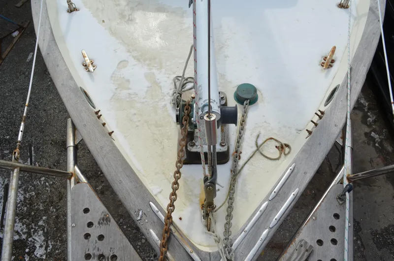 Slide: The Image of Bow of 1982 Young Sun Cutter sailboat with anchor chains and deck fittings. - 34