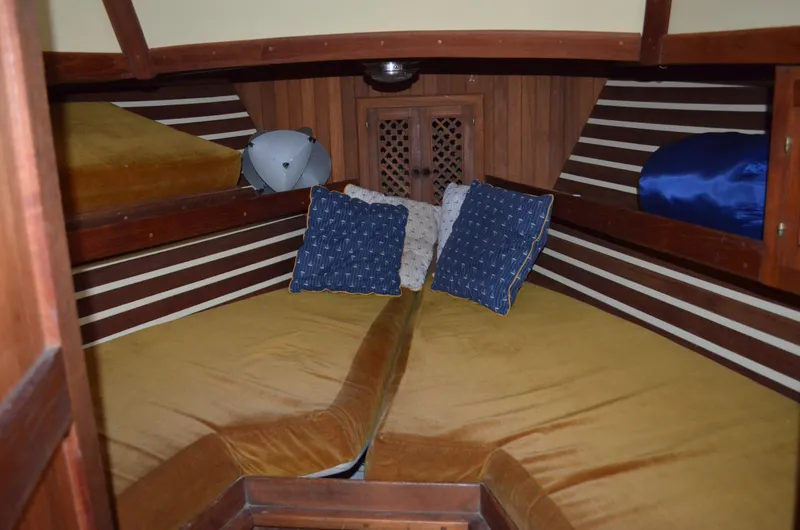 Slide: The Image of Cozy cabin interior of 1982 Young Sun Cutter sailboat with cushions and wooden accents. - 4