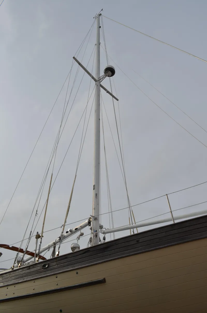 Slide: The Image of 1982 Young Sun Cutter sailboat mast against cloudy sky. - 40